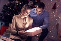 Happy Couple Opening Christmas Present Royalty Free Stock Photo