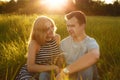 Happy couple outdoor. Smiling couple relaxing on the green grass. Girl and boy over nature green background. Good relationships. R Royalty Free Stock Photo