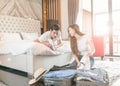 Happy couple packing suitcase on floor in room use tablet for search travel trip online. Royalty Free Stock Photo