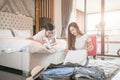 Happy couple packing suitcase on floor in room use tablet for search travel trip online. Royalty Free Stock Photo