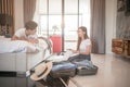 Happy couple packing suitcase on floor in room use tablet for search travel trip online. Royalty Free Stock Photo