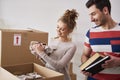 Happy couple packing their stuff into boxes Royalty Free Stock Photo