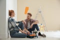 Happy couple with paint planning home repair Royalty Free Stock Photo