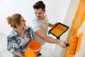 Happy couple painting wall indoors. Home repair Royalty Free Stock Photo