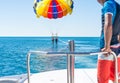 Happy couple Parasailing in Dominicana beach in summer. Couple under parachute hanging mid air. Having fun. Paradise. Pos