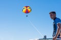 Happy couple Parasailing in Dominicana beach in summer. Couple under parachute hanging mid air. Having fun. Tropical Paradise. Pos Royalty Free Stock Photo