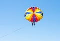 Happy couple Parasailing in Dominicana beach in summer. Couple under parachute hanging mid air. Having fun. Tropical Paradise. Pos Royalty Free Stock Photo