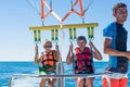 Happy couple Parasailing in Dominicana beach in summer. Couple under parachute hanging mid air. Having fun. Tropical Paradise. Pos Royalty Free Stock Photo