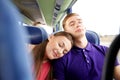 Happy couple or passengers sleeping in travel bus Royalty Free Stock Photo