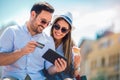 Happy couple paying on line with credit card and digital tablet