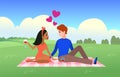 Happy couple on picnic. People relax in nature together, man and woman on date with vine valentines or wedding card