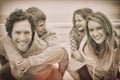 Happy couple piggybacking kids at beach Royalty Free Stock Photo