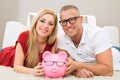 Happy couple with piggybank