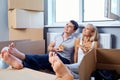 Happy couple with pizza in a new apartment for a housewarming. Royalty Free Stock Photo