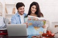 Happy couple planning vacation trip, studying map Royalty Free Stock Photo