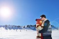 Happy couple playful together during winter holidays vacation outside in snow park Royalty Free Stock Photo