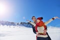 Happy couple playful together during winter holidays vacation outside in snow park Royalty Free Stock Photo