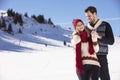 Happy couple playful together during winter holidays vacation outside in snow park Royalty Free Stock Photo