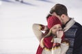 Happy couple playful together during winter holidays vacation outside in snow park Royalty Free Stock Photo