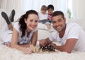 Happy couple playing chess on floor in living-room Royalty Free Stock Photo