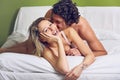 Happy couple playing and joking in bed Royalty Free Stock Photo