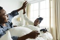 A happy couple playing video game in bed Royalty Free Stock Photo