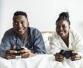 A happy couple playing video game in bed Royalty Free Stock Photo