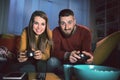 Happy couple playing video games together at home Royalty Free Stock Photo