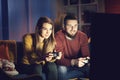 Happy couple playing video games together at home Royalty Free Stock Photo