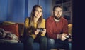 Happy couple playing video games together at home Royalty Free Stock Photo