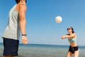 Happy couple playing volleyball on summer beach Royalty Free Stock Photo