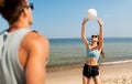 Happy couple playing volleyball on summer beach Royalty Free Stock Photo