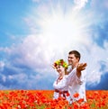 Happy couple on poppies field 2 Royalty Free Stock Photo