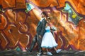 Happy couple posing on background graffiti