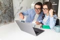 Happy young couple with raised arms of win celebrate looking on laptop in kitchen Royalty Free Stock Photo