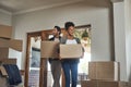 Happy couple, real estate and boxes in new home for renovation, investment or relocation together. Interracial man and Royalty Free Stock Photo