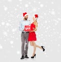 Happy couple with red sale sign over snow Royalty Free Stock Photo