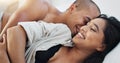 Happy couple, relax and kissing on bed for embrace, love or morning romance in trust or care at home. Young man and Royalty Free Stock Photo