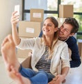 Happy couple, relax and moving in with selfie in box for photography, new home or picture at apartment. Man and woman Royalty Free Stock Photo