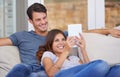 Happy couple, relax and sofa with tablet for entertainment, movie or social media together at home. Man and woman Royalty Free Stock Photo