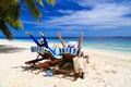 Happy couple relax on a tropical beach Royalty Free Stock Photo