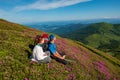 Happy couple relaxing among flowering pink rhododendrons Royalty Free Stock Photo