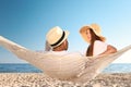 Happy couple relaxing in hammock on beach Royalty Free Stock Photo