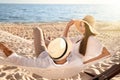 Happy couple relaxing in hammock on beach Royalty Free Stock Photo