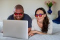 Happy couple relaxing at home with lap top Royalty Free Stock Photo