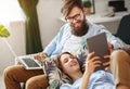 Happy couple relaxing at home with laptop and tablet Royalty Free Stock Photo