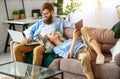 Happy couple relaxing at home with laptop and tablet Royalty Free Stock Photo