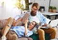 Happy couple relaxing at home with laptop and tablet Royalty Free Stock Photo