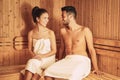 Happy couple relaxing inside sauna spa resort hotel - Romantic young lovers having relaxing day in luxury steam bath salon