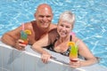 Happy couple relaxing by the pool Royalty Free Stock Photo